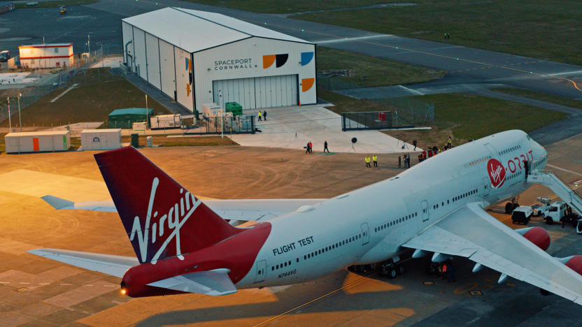 A Virgin Orbit flight text plane sits near a runway terminal in Cornwall England.