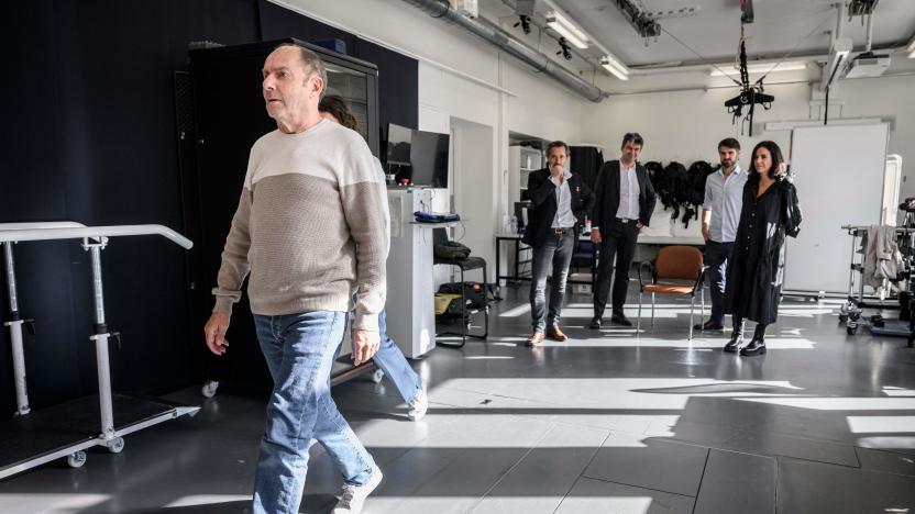 (From L) Marc, a French patient suffering from parkinson's disease, fitted with a new neuroprosthesis, walks in front of Swiss Professor of neuroscience at the Swiss Federal Institute of Technology in Lausanne (EPFL) Lausanne University Hospital (CHUV) and Lausanne University (UNIL) and co-director of NeuroRestore, Gregoire Courtine, project manager Tomislav Milekovic, project manager and head of Parkinson's activities at NeuroRestore, Eduardo Martin Moraud, swiss neurosurgeon professor and co-director of NeuroRestore Jocelyne Bloch, in Lausanne, on November 3, 2023. Neuroscientists from Inserm, CNRS and the University of Bordeaux in France, together with Swiss researchers and neurosurgeons (EPFL/CHUV/UNIL), have designed and tested a 'neuroprosthesis' designed to correct the walking problems associated with Parkinson's disease. (Photo by GABRIEL MONNET / AFP) / "The erroneous mention appearing in the metadata of this photo by GABRIEL MONNET has been modified in AFP systems in the following manner: [Marc] instead of [Marc Gautier]. Please immediately remove the erroneous mention[s] from all your online services and delete it (them) from your servers. If you have been authorized by AFP to distribute it (them) to third parties, please ensure that the same actions are carried out by them. Failure to promptly comply with these instructions will entail liability on your part for any continued or post notification usage. Therefore we thank you very much for all your attention and prompt action. We are sorry for the inconvenience this notification may cause and remain at your disposal for any further information you may require." (Photo by GABRIEL MONNET/AFP via Getty Images)