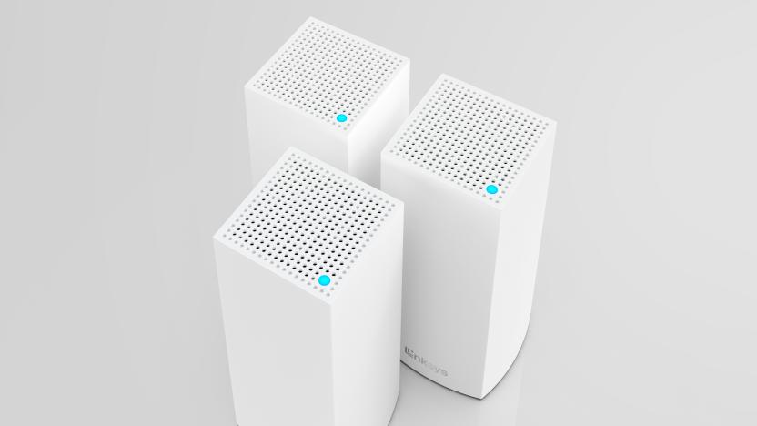 The rectangular Linksys Hydra 6 and Atlas 6 routers seen from above at a slight angle, as they're grouped together like a trio of little white skyscrapers.