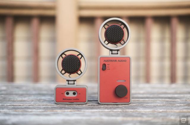 The Austrian Audio MiCreator in two parts: Two round microphones sit atop one smaller and one larger rectangular bases facing the camera and seen on a weathered wooden outdoor table.