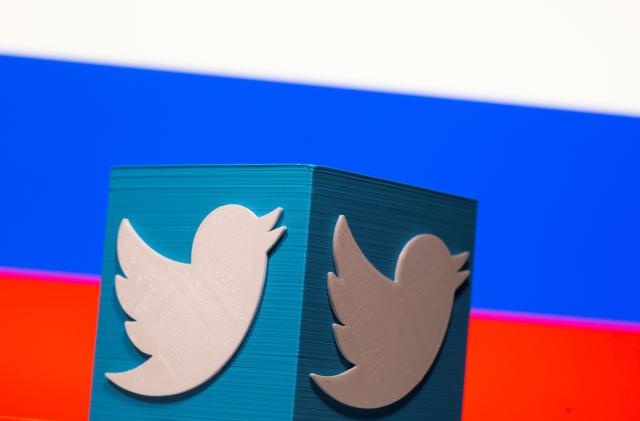 A 3D-printed Twitter logo is pictured in front of a displayed Russian flag in this illustration taken March 10, 2021. REUTERS/Dado Ruvic/Illustration