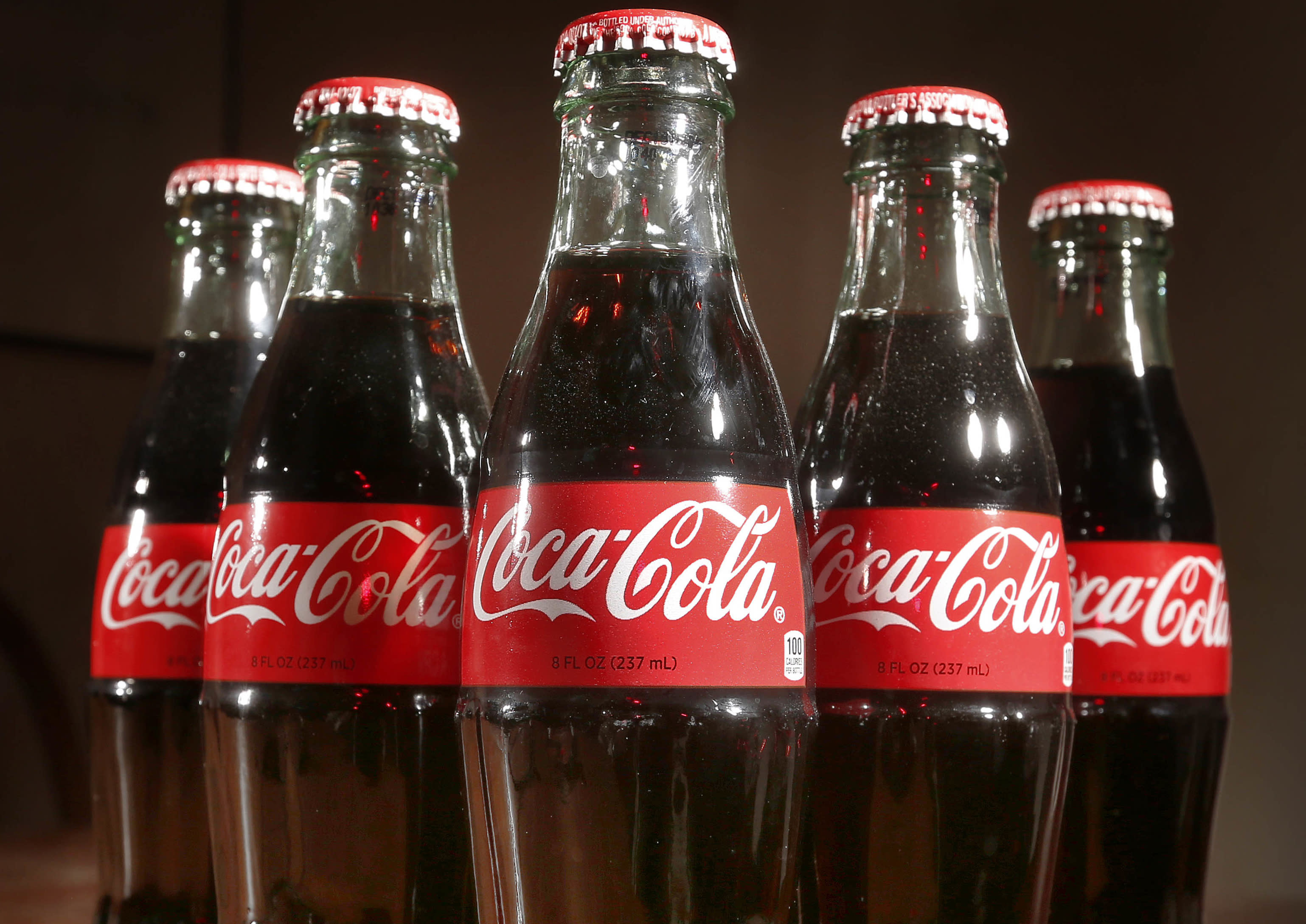 Coke profit falls 28 percent, but beats expectations