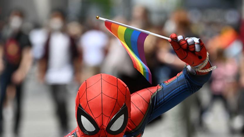 An young man dressed up as comic book character Spider-Man holds up a rainbow flag during a Christopher Street action day of the CSD Pride Week in the center of Munich, southern Germany, on July 10, 2021. - Several parties, associations and organisations present their work on this day in downtown Munich. (Photo by Christof STACHE / AFP) (Photo by CHRISTOF STACHE/AFP via Getty Images)