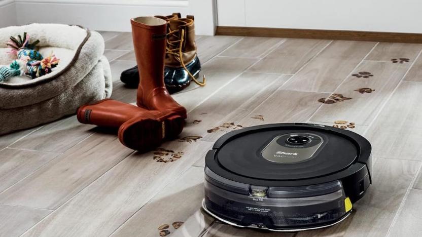 The Shark vacuum cleans a dirty wood floor. 