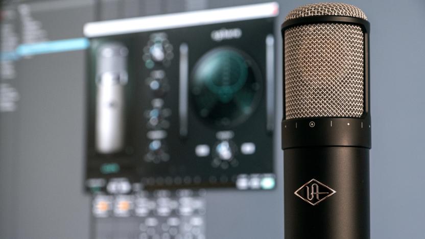 Universal Audio's Sphere LX modeling microphone is pictured infront of a PC monitor.