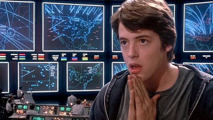 Still from the 1983 film ‘Wargames,’ featuring a young (and nervous) Matthew Broderick in front of a series of national defense screens and controls. His hands are pressed together below his chin.