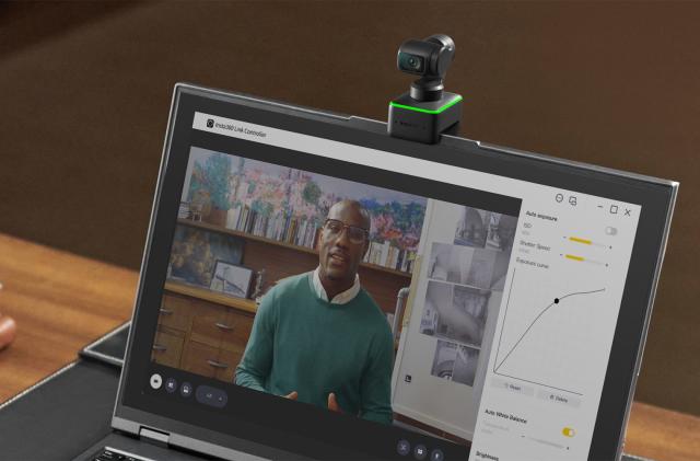 An Insta360 Link webcam attached to the top of a laptop.