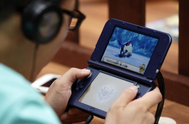 CHIBA, JAPAN - SEPTEMBER 16:  A visitor plays a video game on a Nintendo Co. 3DS LL portable video game player at the Tokyo Game Show 2016 on September 16, 2016 in Tokyo, Japan. The Tokyo Game Show 2016 is held from September 15 to Septem  (Photo by Tomohiro Ohsumi/Getty Images)