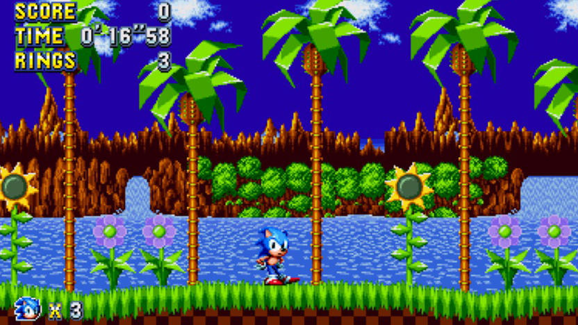 A screenshot of Sonic Mania Plus showing Sonic, an anthropomorphic blue hedgehog, against a background of computer-drawn beach and palm trees. 