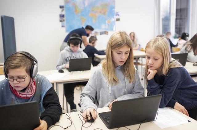 Children in classroom using laptops