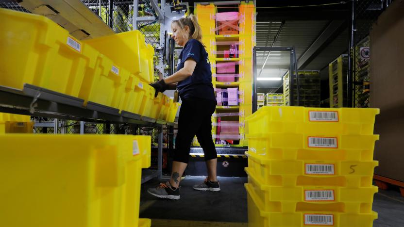 An Amazon employee works to stow items inside of shelves delivered by robots inside of an Amazon fulfillment center on Cyber Monday in Robbinsville, New Jersey, U.S., December 2, 2019.  REUTERS/Lucas Jackson