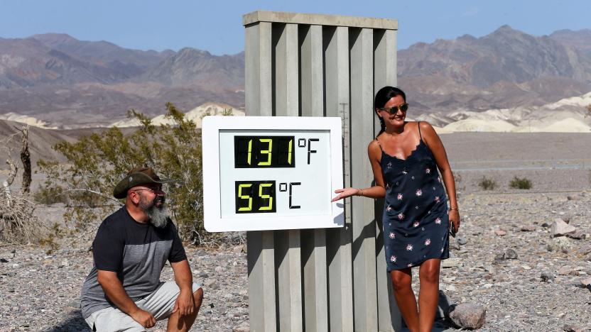 DEATH VALLEY NATIONAL PARK, CALIFORNIA - AUGUST 17: Visitors gather for a photo in front of an unofficial thermometer at Furnace Creek Visitor Center on August 17, 2020 in Death Valley National Park, California. The temperature reached 130 degrees at Death Valley National Park on August 16, hitting what may be the hottest temperature recorded on Earth since at least 1913, according to the National Weather Service. Park visitors have been warned, ‘Travel prepared to survive.’ (Photo by Mario Tama/Getty Images)