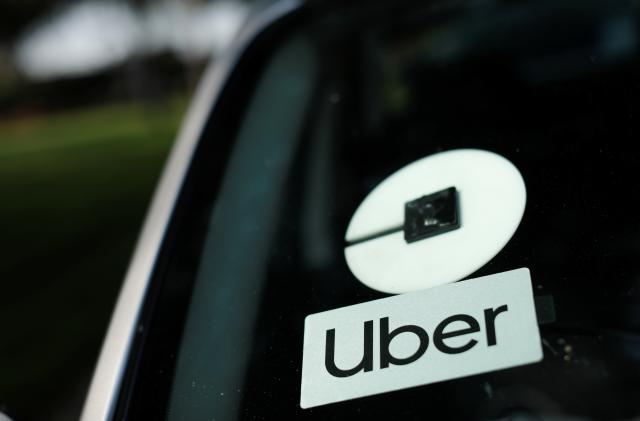 An Uber logo is shown on a rideshare vehicle during a statewide day of action to demand that ride-hailing companies Uber and Lyft follow California law and grant drivers "basic employee rights'', in Los Angeles, California, U.S., August 20, 2020. REUTERS/Mike Blake