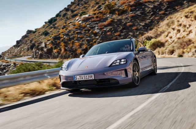 A Porsche drives along the coastal highway.