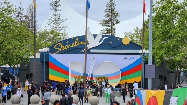 The entrance to Shoreline Amphitheatre during Google I/O 2023. Many people are standing around in front of a sign that says I/O.