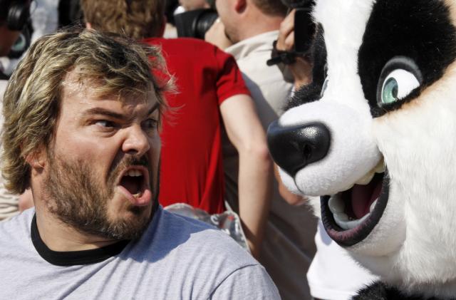 Voice actor Jack Black shouts near life-sized pandas during a beach photo call for the animated film "Kung Fu Panda" as the 61st Cannes Film Festival starts, May 14, 2008.  REUTERS/Jean-Paul Pelissier  (FRANCE)