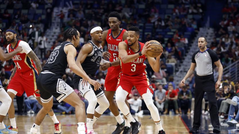 New Orleans Pelicans guard CJ McCollum (3) and San Antonio Spurs guard Devonte' Graham (4) in the first half of an NBA basketball game in New Orleans, Tuesday, March 21, 2023. (AP Photo/Tyler Kaufman)