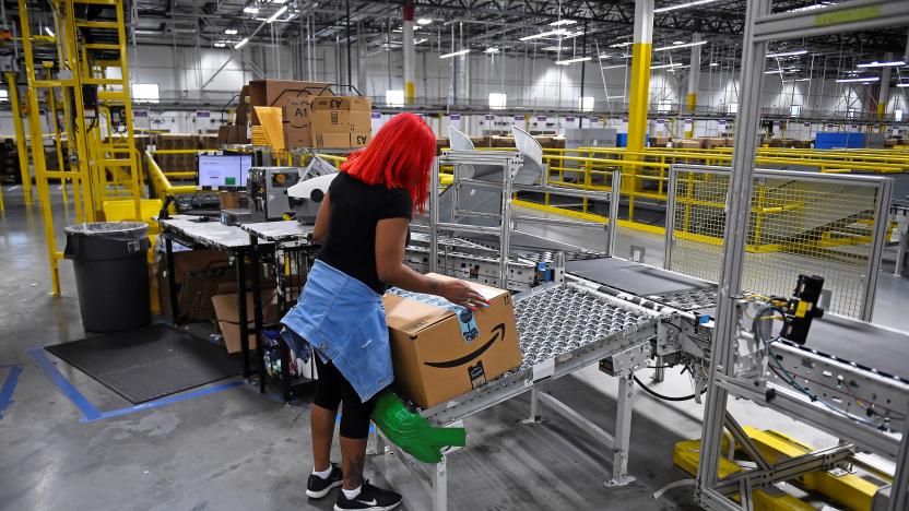 A worker takes a delivery box off the line at the Amazon fulfillment center in Baltimore, Maryland, U.S., April 30, 2019. 