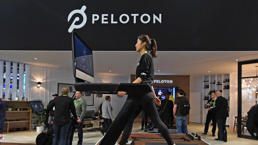 A woman walks on a Peloton treadmill in the Peloton showroom.