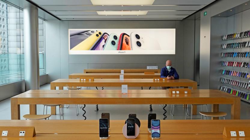 A man wearing face mask sits at an Apple Store in Hong Kong Wednesday, April 1, 2020.