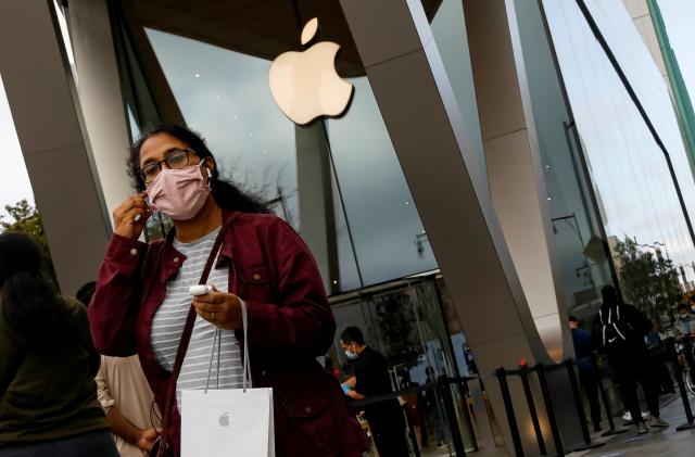 A customer exits after picking up Apple's new 5G iPhone 12 that went on sale, as the coronavirus disease (COVID-19) outbreak continues, at an Apple Store in Brooklyn, New York, U.S. October 23, 2020.  REUTERS/Brendan McDermid