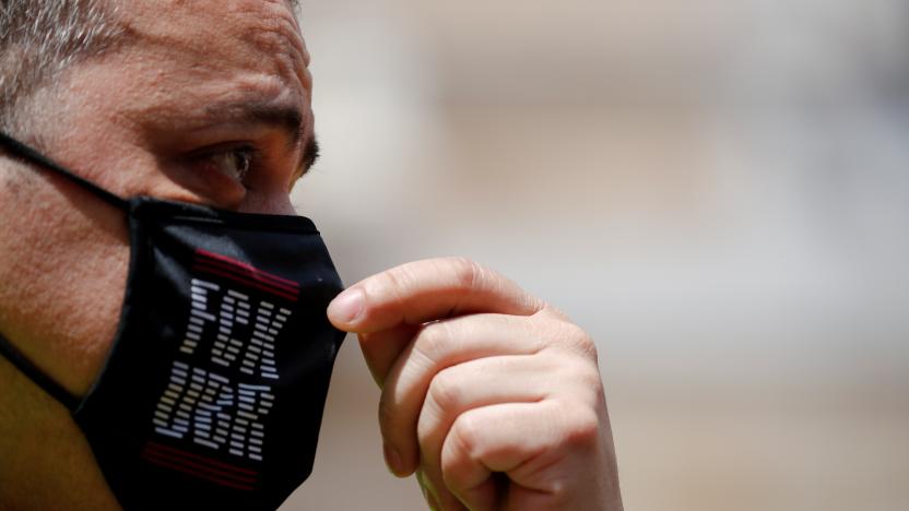 Taxi driver and union member Tito Alvarez adjusts his mask as he attends a protest against the regulation of VTC cars (Uber and Cabify) in Barcelona, Spain, May 20, 2021. REUTERS/Albert Gea