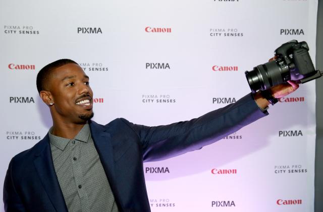 AUSTIN, TX - OCTOBER 01:  Actor Michael B. Jordan takes a selfie with a Canon at the Canon PIXMA PRO City Senses Galary at Austin Music Hall in Austin on October 1, 2014.  (Photo by Tasos Katopodis/Getty Images for Canon)