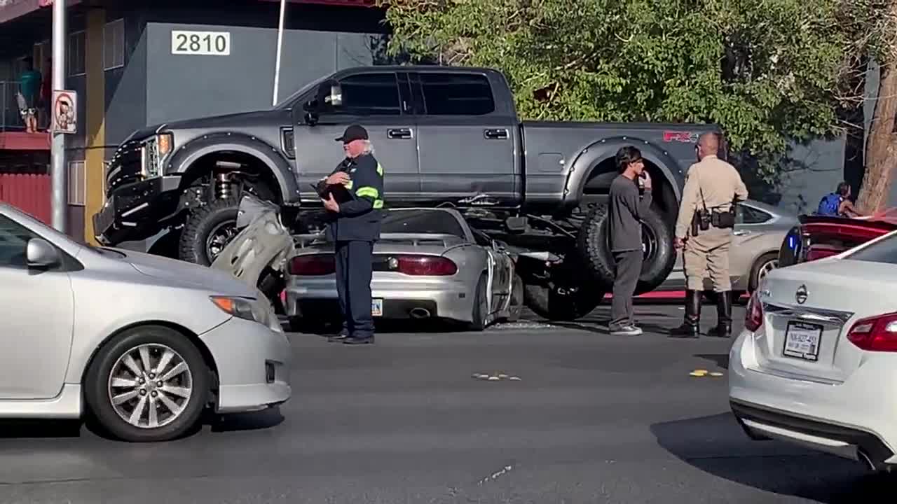 Pickup truck lays on sedan after crash on Eldora and Decatur