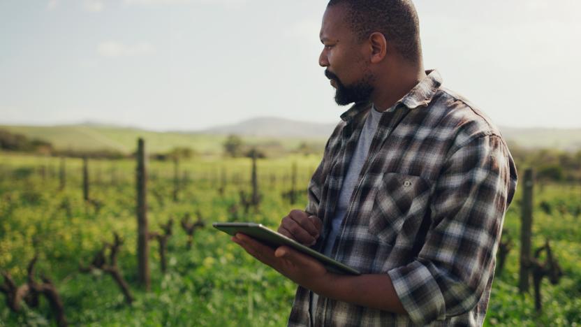 Shot of a mature man using a digital tablet while working on a farm