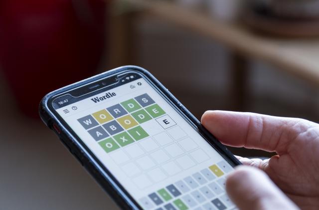 Woman plays Wordle on her smartphone from the living room of her home awaits the result from just three guesses on 21st April 2022 in Birmingham, United Kingdom. Wordle is a web-based word game played by millions of users / players worldwide often on their mobile devices. The game was created and developed by software engineer Josh Wardle, and owned by The New York Times Company since 2022. (photo by Mike Kemp/In Pictures via Getty Images)