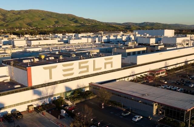 An aerial view shows the Tesla Fremont Factory in Fremont, California on February 10, 2022. - Tesla can hardly make enough electric vehicles to meet booming demand, but behind the world's most valuable auto brand is its troubled California factory that makes most of those cars. The Fremont plant near San Francisco has seen a spate of sexual harassment lawsuits, years of racism allegations -- including a California civil rights agency complaint this week -- and even a murder last year (Photo by JOSH EDELSON / AFP) (Photo by JOSH EDELSON/AFP via Getty Images)