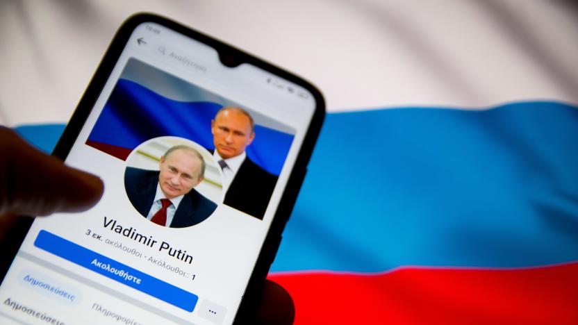 In this photo illustration Vladimir Putin Facebook page seen displayed on a smartphone screen with a flag of Ukraine on computer screen in the background in Athens, Greece on February 25, 2022. (Photo illustration by Nikolas Kokovlis/NurPhoto via Getty Images)