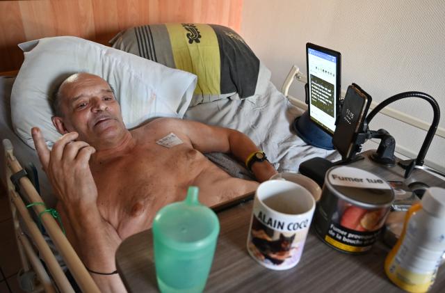 Alain Cocq, suffering from an orphan desease of the blood, rests on his medical bed on August 12, 2020 in his flat in Dijon, northeastern France. - Alain Cocq appeals to the French President to receive the authorization from the medical profession to prescribe a barbiturate. "I am not asking for assisted suicide or euthanasia," he defends himself. "But an ultimate care. Because I am just trying to avoid inhuman suffering", which the Leonetti law currently does not allow regarding the end of life, according to him. Alain has a telephone appointment on August 25, 2020 with the health advisor of the presidency, Anne-Marie Armanteras. (Photo by PHILIPPE DESMAZES / AFP) (Photo by PHILIPPE DESMAZES/AFP via Getty Images)