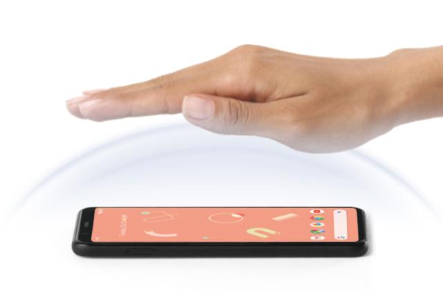 A hand is held above a Google Pixel 4 smartphone.