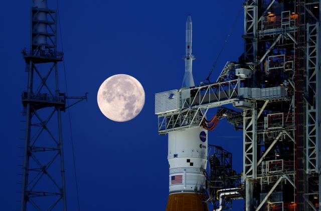 A full moon, known as the "Strawberry Moon" is shown with NASA’s next-generation moon rocket, the Space Launch System (SLS) Artemis 1, at the Kennedy Space Center in Cape Canaveral, Florida, U.S. June 15, 2022. REUTERS/Joe Skipper