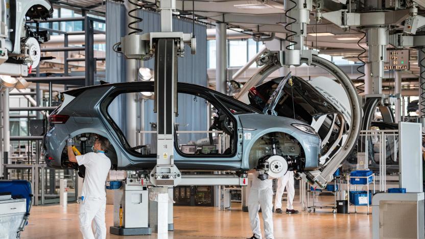 Employees work on the assembly line for the Volkswagen (VW) ID 3 electric car of German carmaker Volkswagen, at the 'Glassy Manufactory' (Glaeserne Manufaktur) production site in Dresden, eastern Germany on June 8, 2021. (Photo by JENS SCHLUETER / AFP) (Photo by JENS SCHLUETER/AFP via Getty Images)