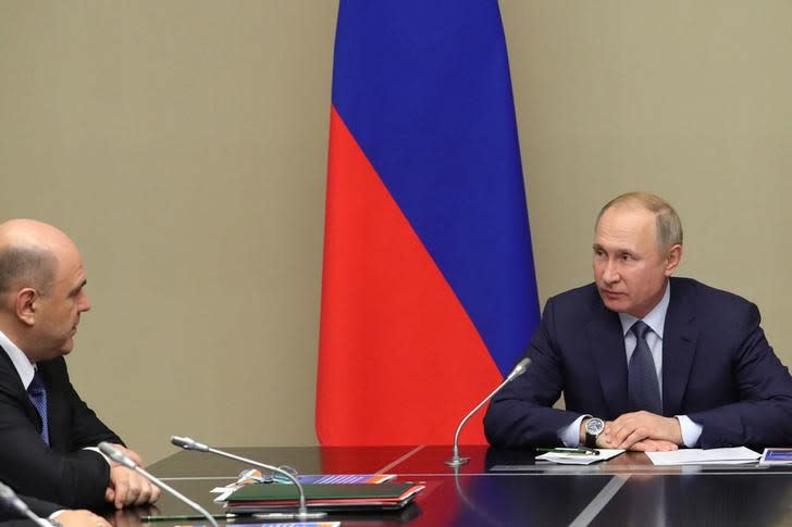 Russian President Vladimir Putin chairs a meeting with members of the Security Council at the Novo-Ogaryovo state residence outside Moscow