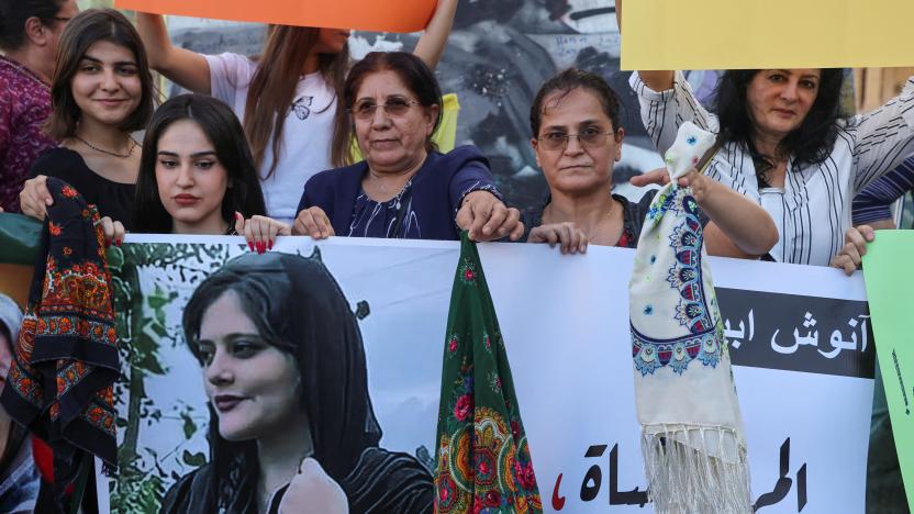 Women hold a picture of Mahsa Amini during a sit-in following her death, at Martyrs' Square in Beirut, Lebanon September 21, 2022. REUTERS/Mohamed Azakir