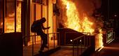 Demonstrators near a fire in Oakland, Calif. (AP)