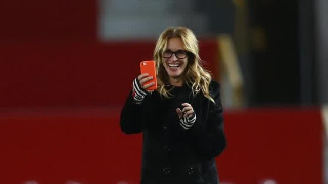 Why is Julia Roberts taking pictures with so many famous soccer players?