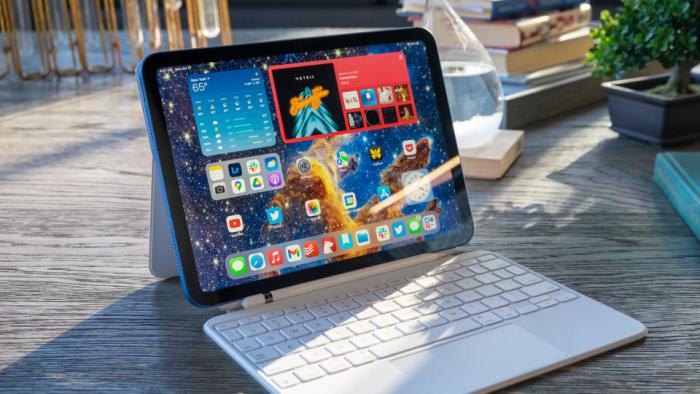 The 10th-gen iPad on an outdoor table with Magic Keyboard attached.
