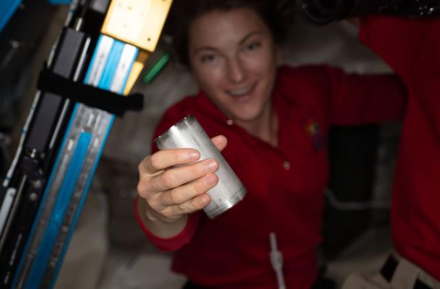 NASA astronaut Kayla Barron replaces a filter in the space station’s Brine Processor Assembly.