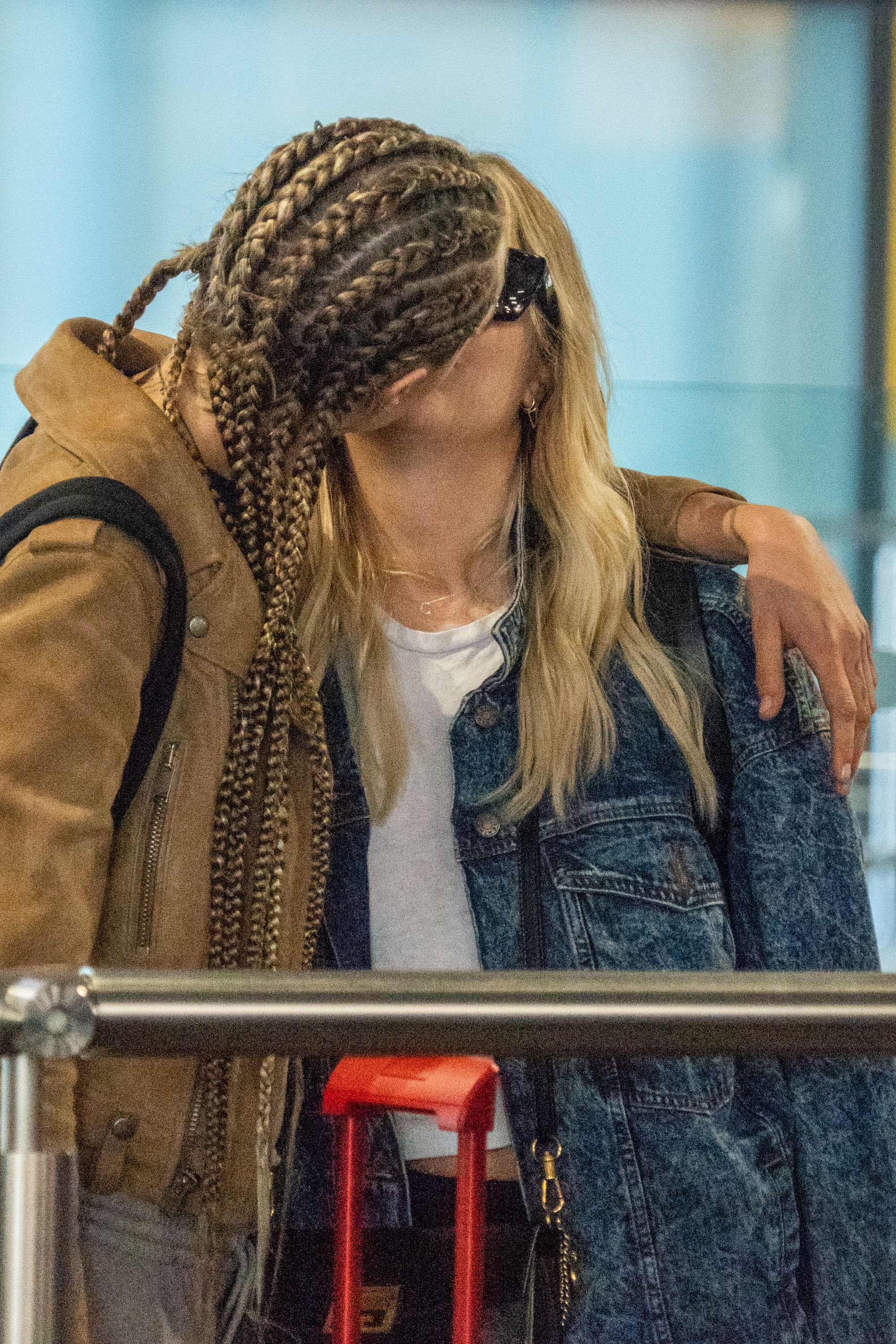 Cara Delevingne and girlfriend Ashley Benson lay on the PDA at JFK