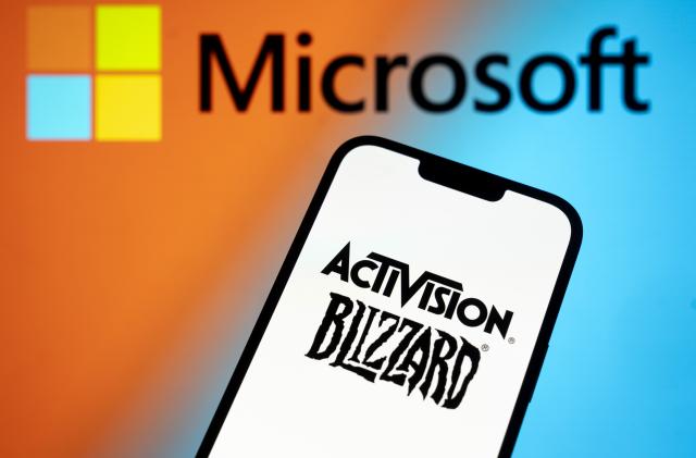 The Activision Blizzard logo is seen with a Microsoft logo in the background in this photo illustration on 13 July, 2023 in Warsaw, Poland. (Photo by Jaap Arriens/NurPhoto via Getty Images)