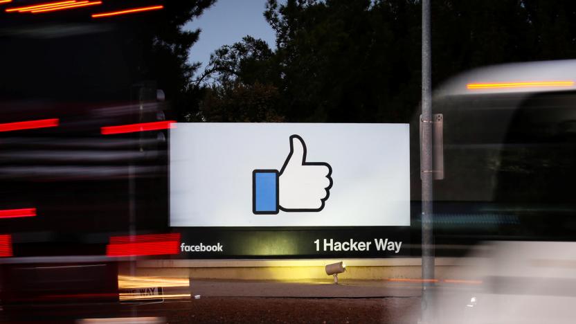 The entrance sign to Facebook headquarters is seen through two moving buses in Menlo Park, California, on Wednesday, October 10, 2018. REUTERS/Elijah Nouvelage