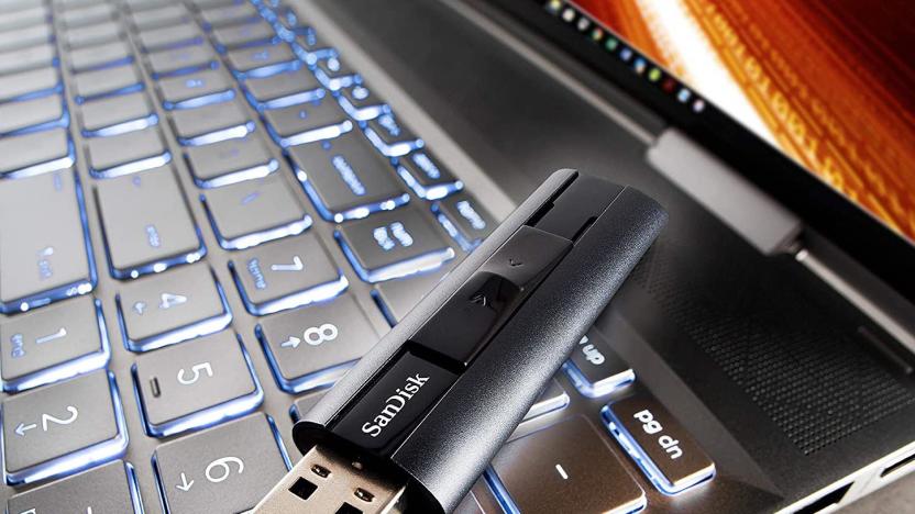 A SanDisk USB sits on top of a laptop keyboard. 