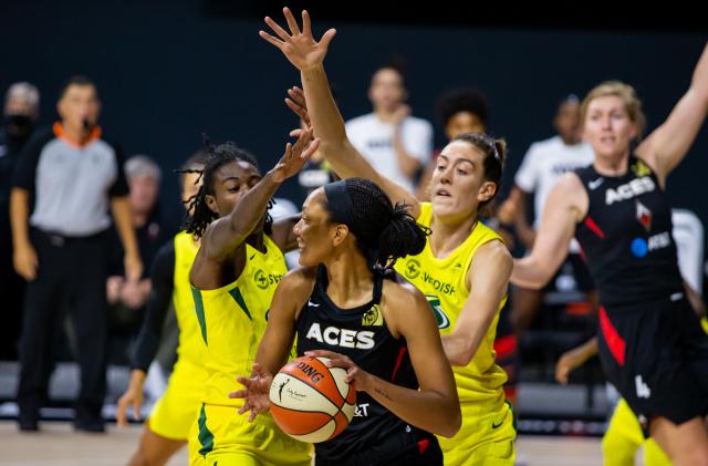 Oct 6, 2020; Bradenton, Florida, USA; Las Vegas Aces center A'ja Wilson (22) looks to pass as Seattle Storm forward Natasha Howard (6) and forward Breanna Stewart (30) defend during game three of the 2020 WNBA Finals at IMG Academy. Mandatory Credit: Mary Holt-USA TODAY Sports