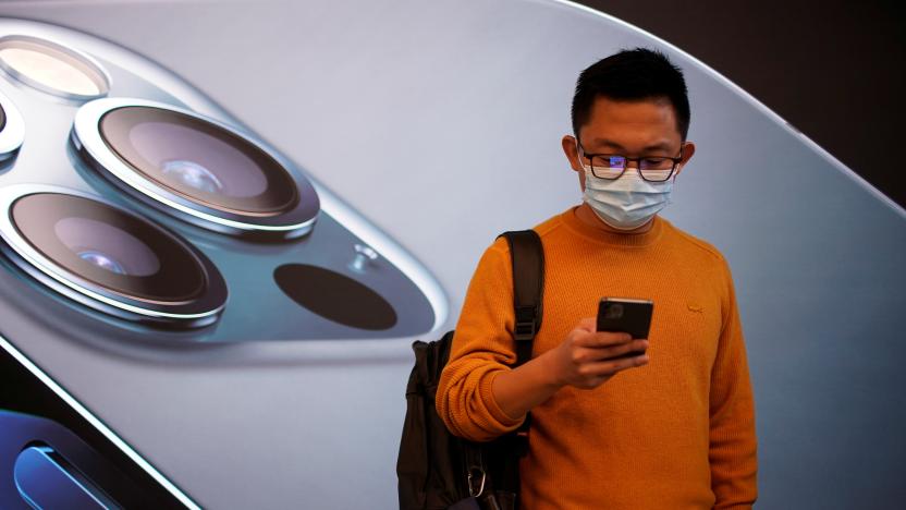 A man wears a face mask while waiting at an Apple Store before Apple's 5G new iPhone 12 go on sale, as the coronavirus disease (COVID-19) outbreak continues in Shanghai China October 23, 2020. REUTERS/Aly Song