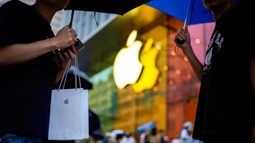 A man holds a bag with a new iPhone inside as Apple's new iPhone 15 officially goes on sale across China, next to an Apple Store, in Shanghai, China September 22, 2023. REUTERS/Aly Song