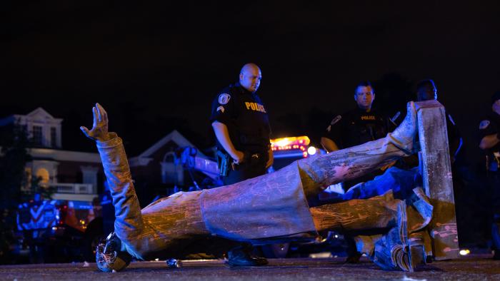 (FILES) In this file photo a statue of Confederate States President Jefferson Davis lies on the street after protesters pulled it down in Richmond, Virginia, on June 10, 2020. - The symbols of the Confederate States and its support for slavery are being targeted for removal following the May 25, 2020, death of George Floyd while in police custody. (Photo by Parker Michels-Boyce / AFP) (Photo by PARKER MICHELS-BOYCE/AFP via Getty Images)